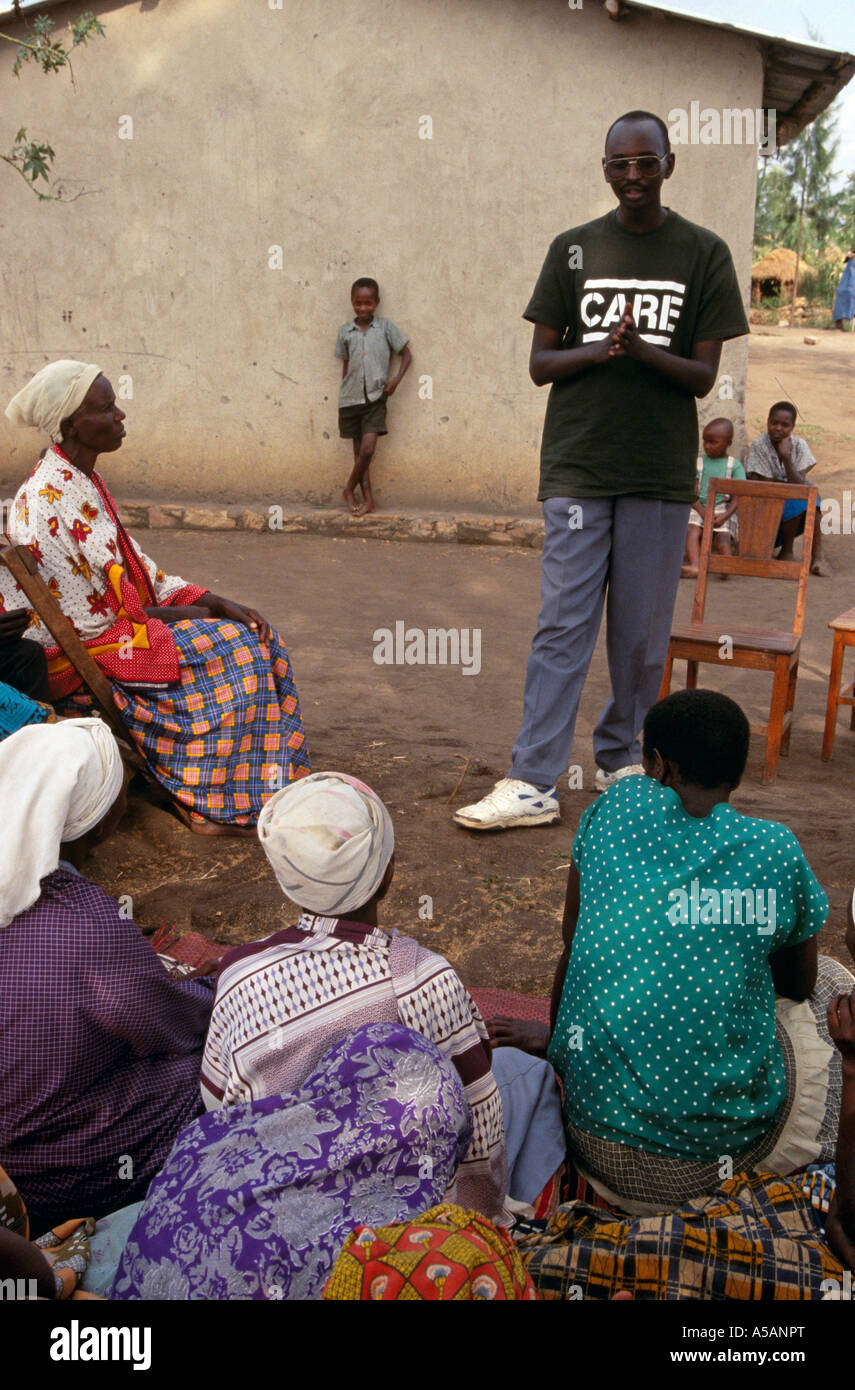 A Care volunteer speaks to a group of people in Rwanda Africa Stock ...