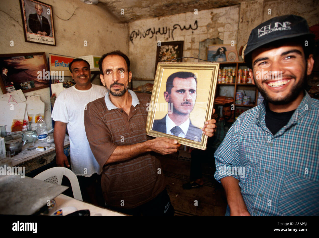 Men holding a picture of Bashar al Assad in Beirut Lebanon Stock Photo