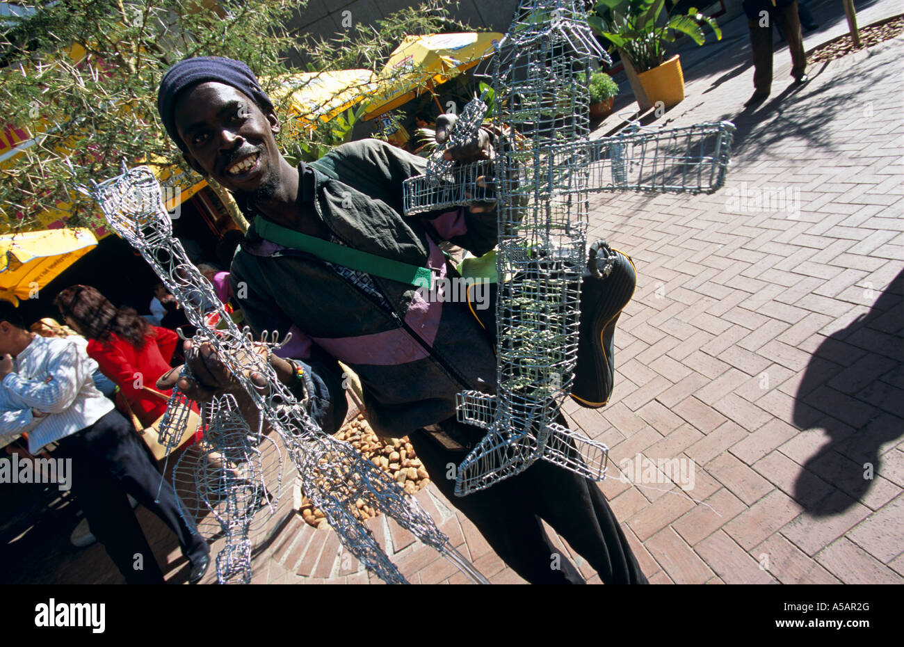 Street vendor selling wire toys on walkway, Johannesburg, South Africa