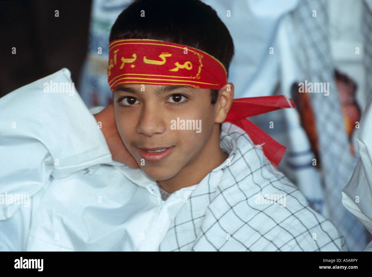 A boy wearing a religious headband in Teheran Iran Stock Photo Alamy