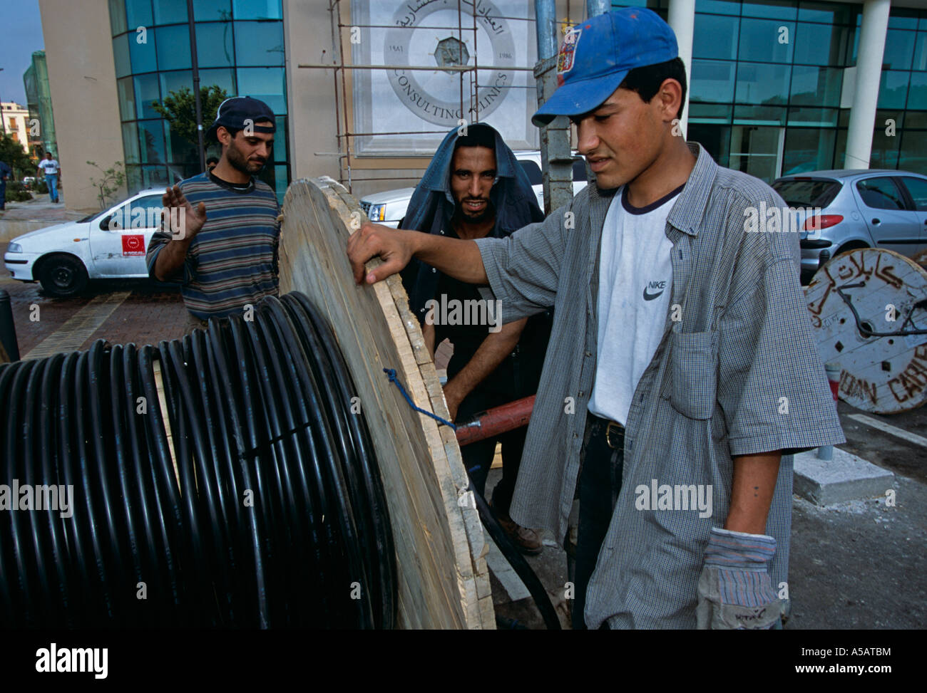 Workers fixing telephone lines in Beirut Stock Photo - Alamy