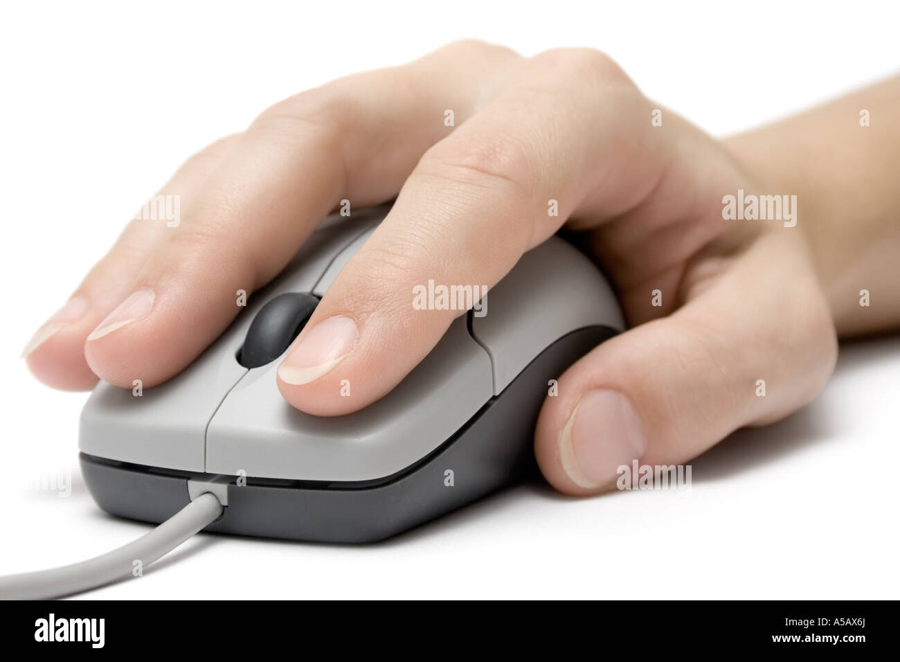 Female hand using a grey computer mouse. Isolated on white background. Stock Photo
