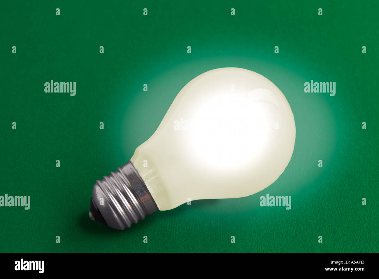 Electric light bulb on green background Stock Photo