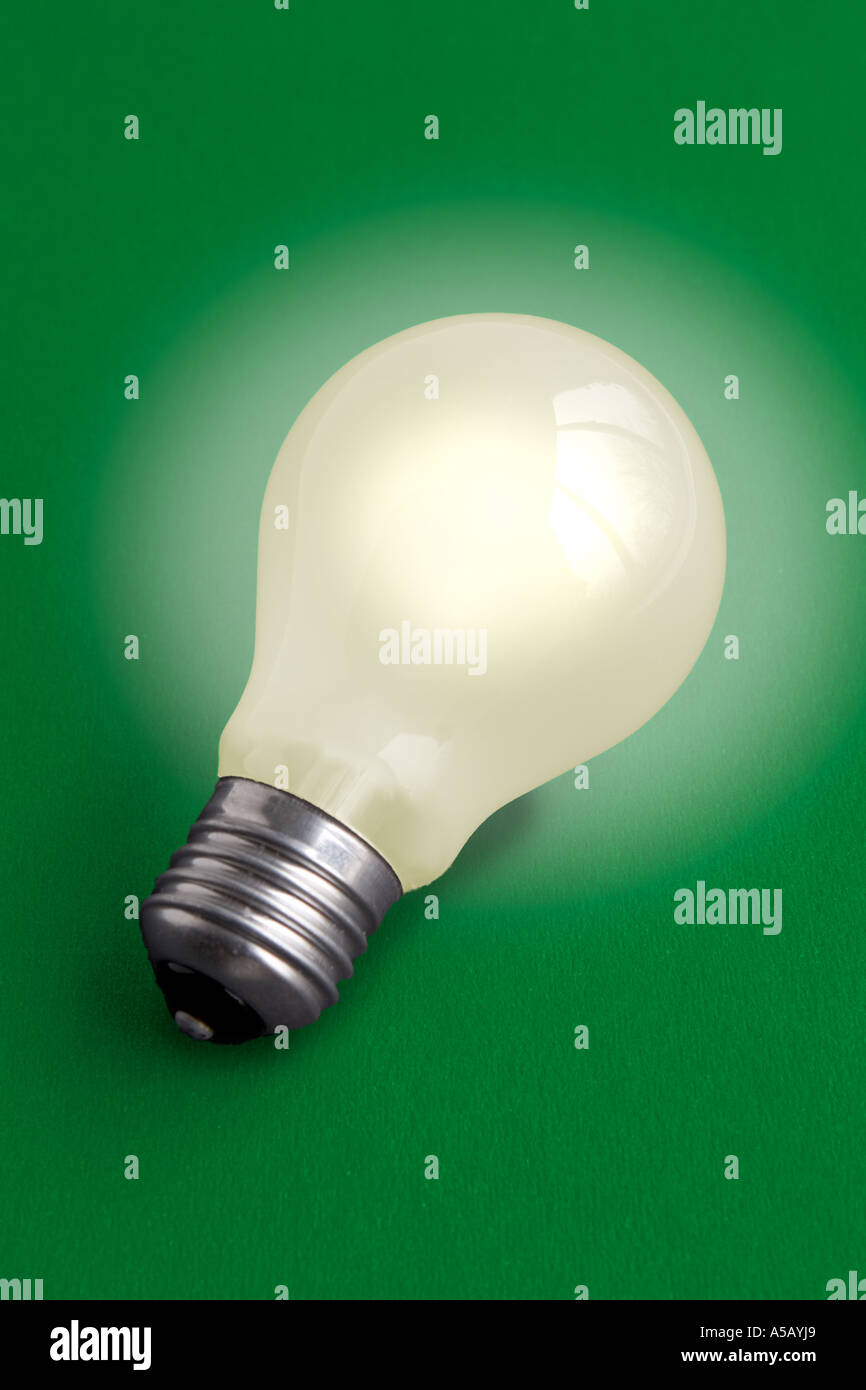 Electric light bulb on green background Stock Photo