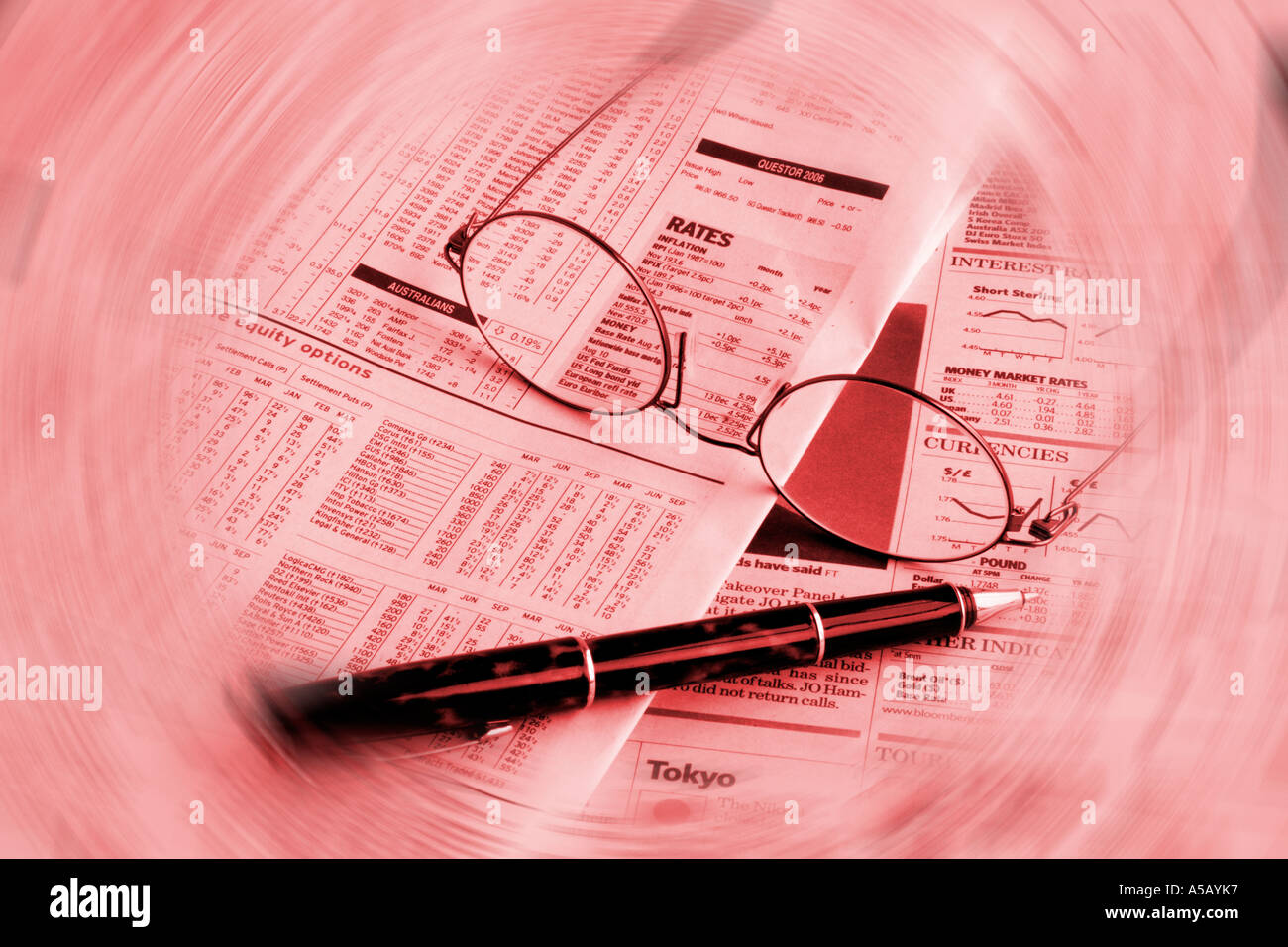 Financial newspaper pen and glasses Stock Photo