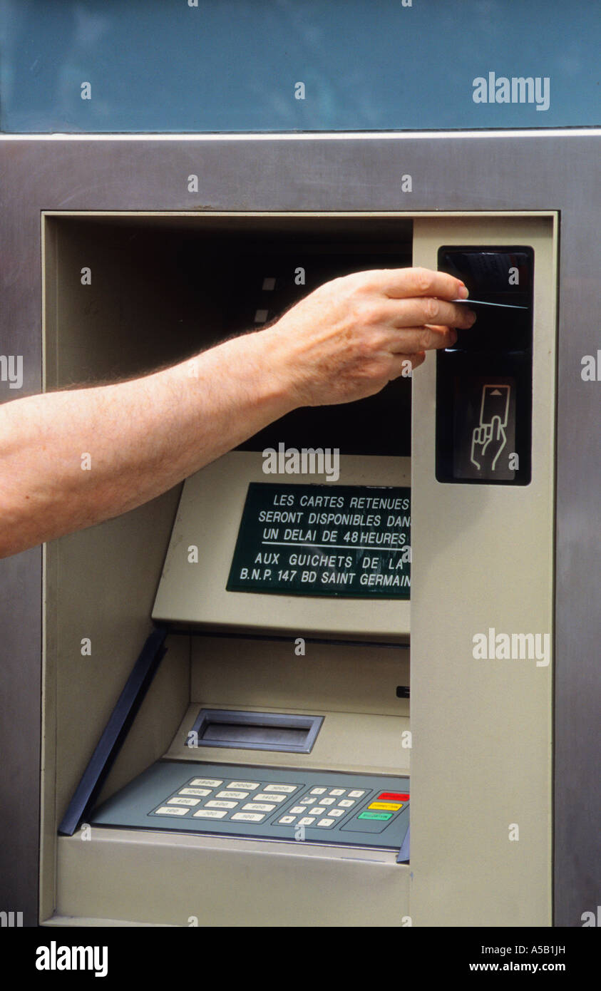 Person Putting a Bank Card in ATM Machine Europe France Stock Photo