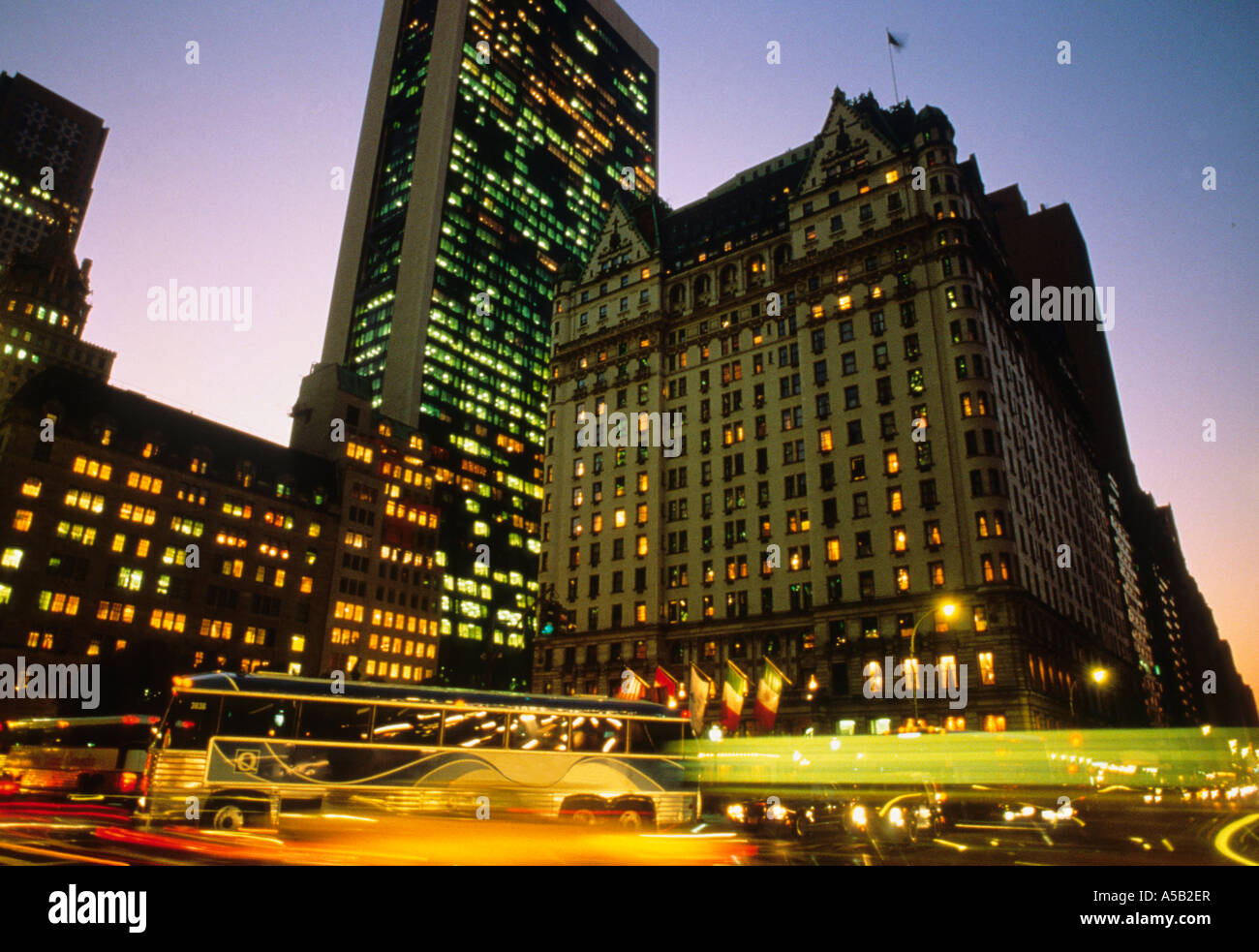 The Plaza Hotel, 5th Avenue, New York, Grand Army Plaza evening. Heavy traffic, light trails and The Plaza Hotel, 5th Avenue, New York, Grand Army Plaza evening. Heavy traffic, light trails and