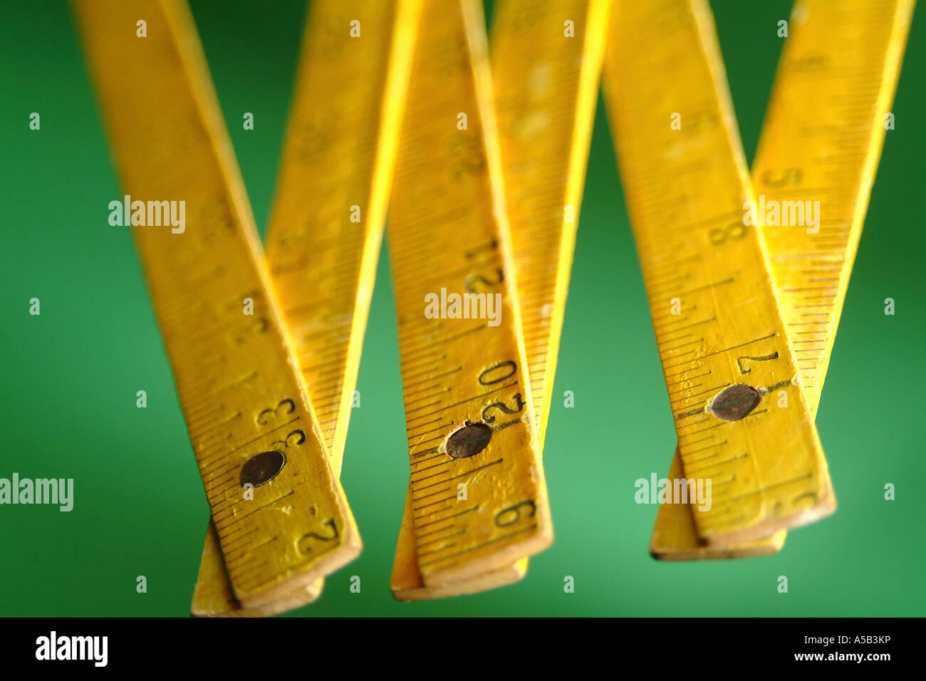 Collapsible wooden measuring stick with numbers. Stock Photo