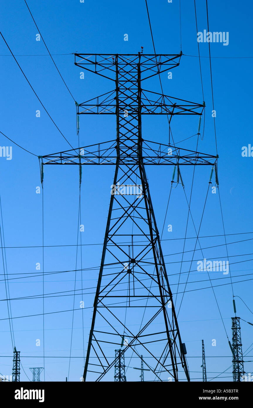 Network of hydro electric power lines on hydro tower against a blue sky ...