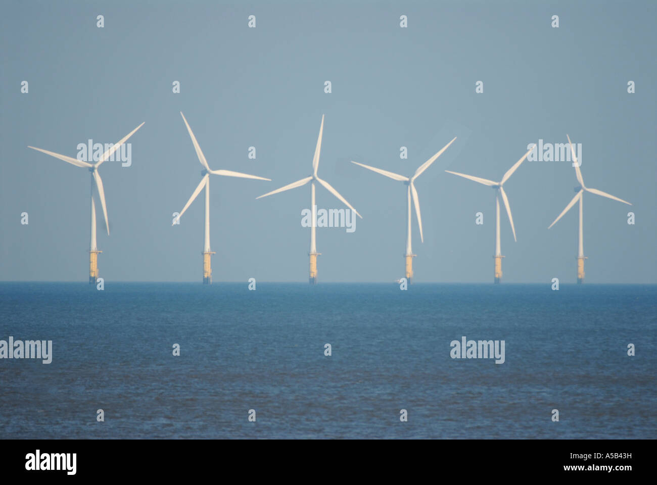 A row of Wind Turbines in the sea Stock Photo