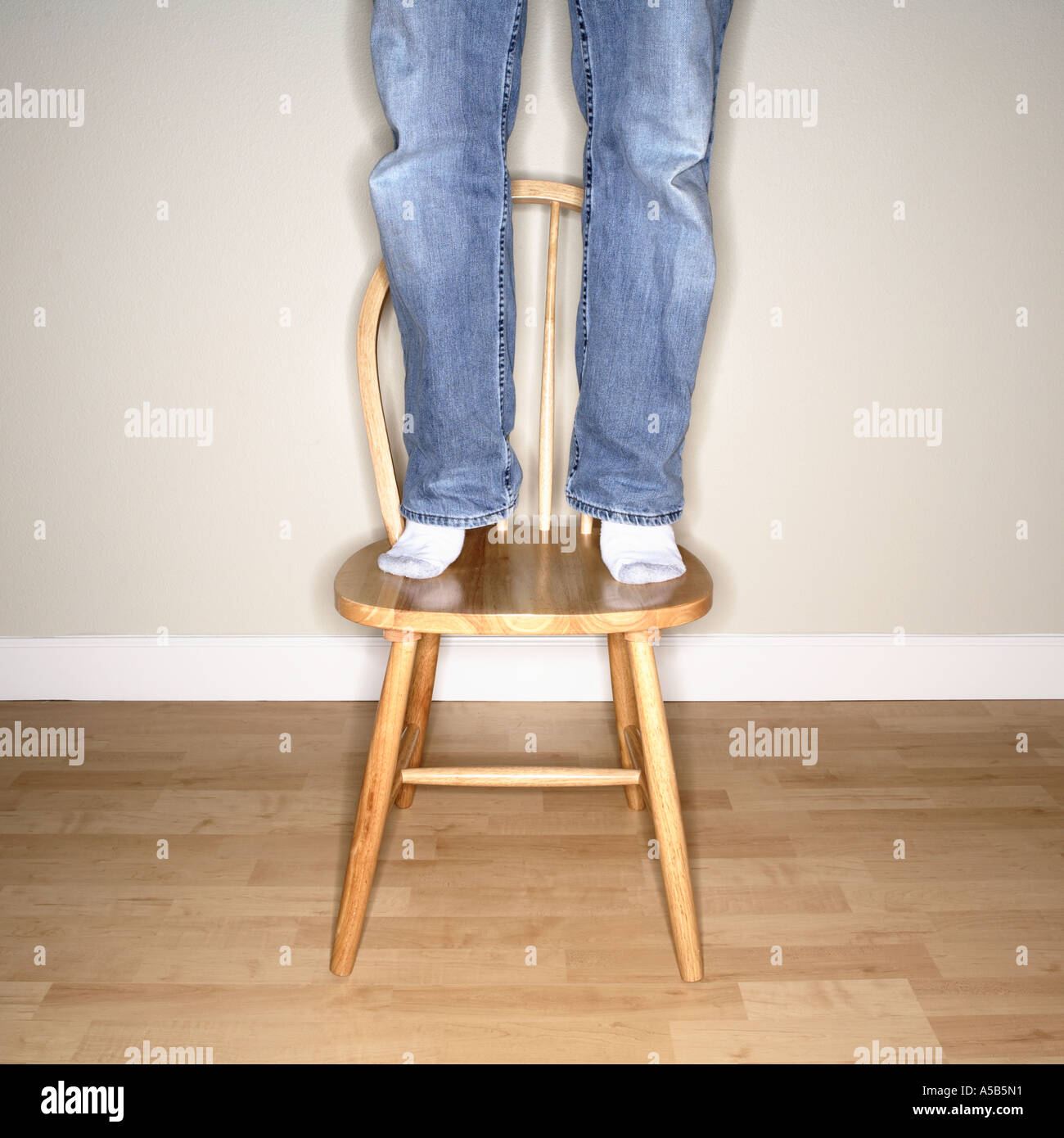 Man standing feet on chair hi res stock photography and images Alamy