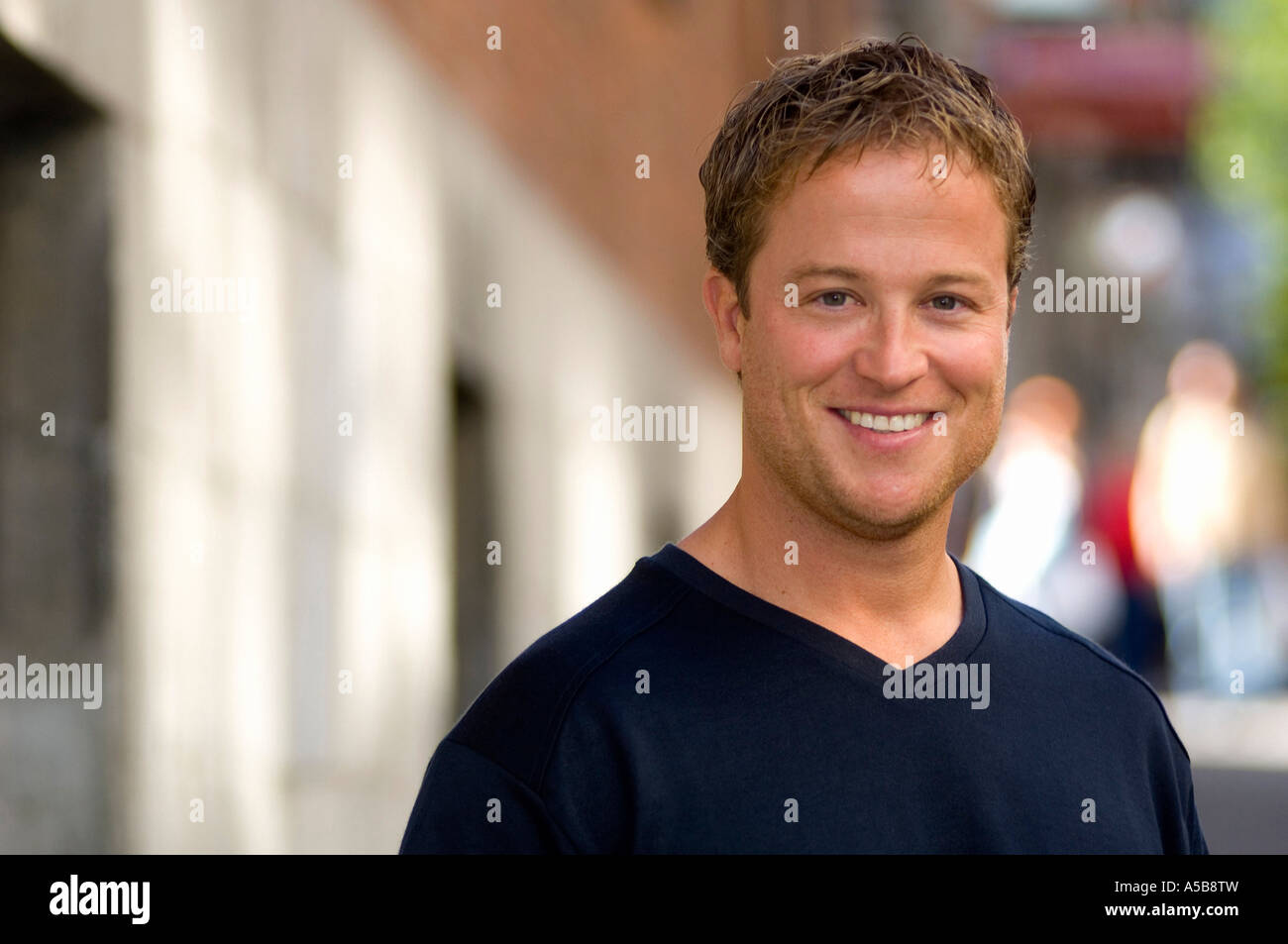 Portrait of young smiling man outdoors Stock Photo - Alamy