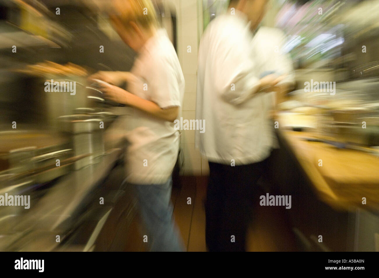 Team of busy cooks in restaurant kitchen Stock Photo - Alamy