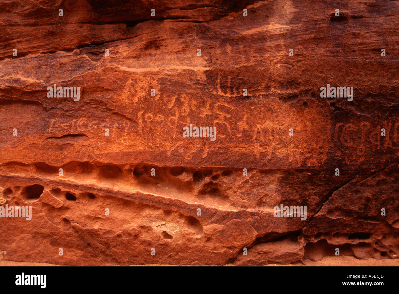 Ancient Nabatean Petroglyphs rock engravings in Khazali Canyon. Wadi Rum desert Jordan Stock Photo