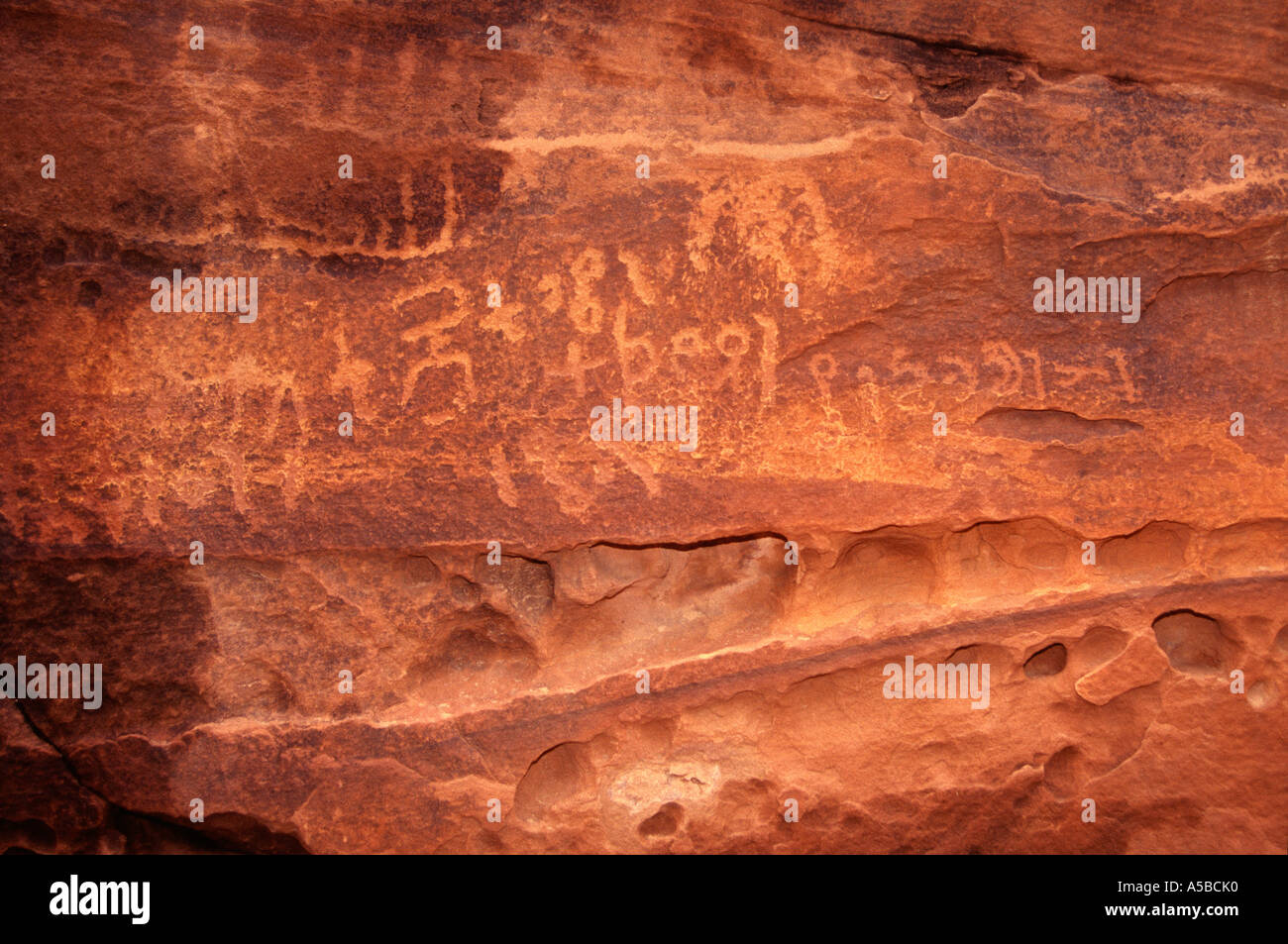 Rock engravings ( petroglyphs ) carved by the Nabataean people in Khazali Canyon. in the desert of Wadi Rum, Southern Jordan Stock Photo