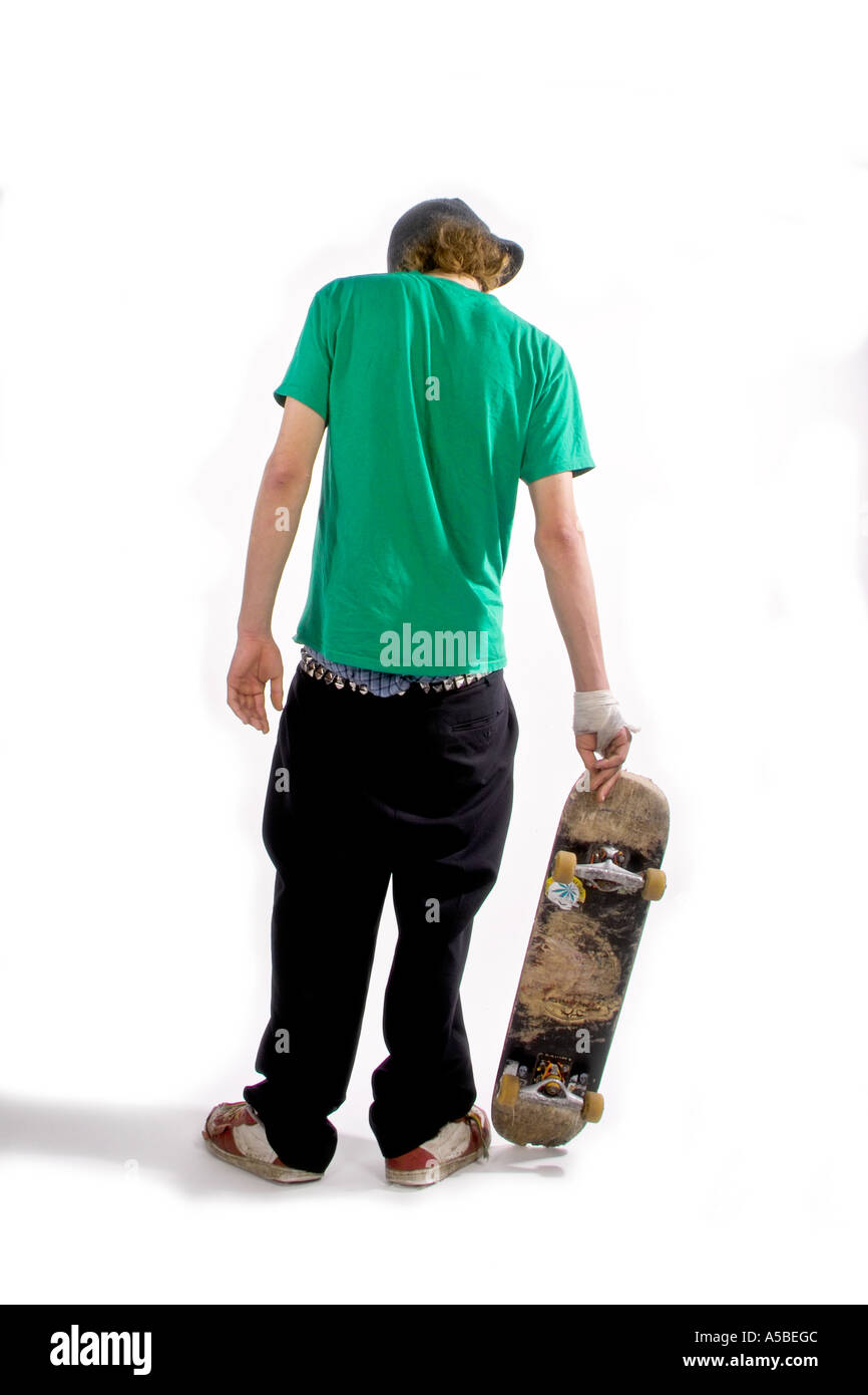 Skateboarder holding his board Stock Photo Alamy