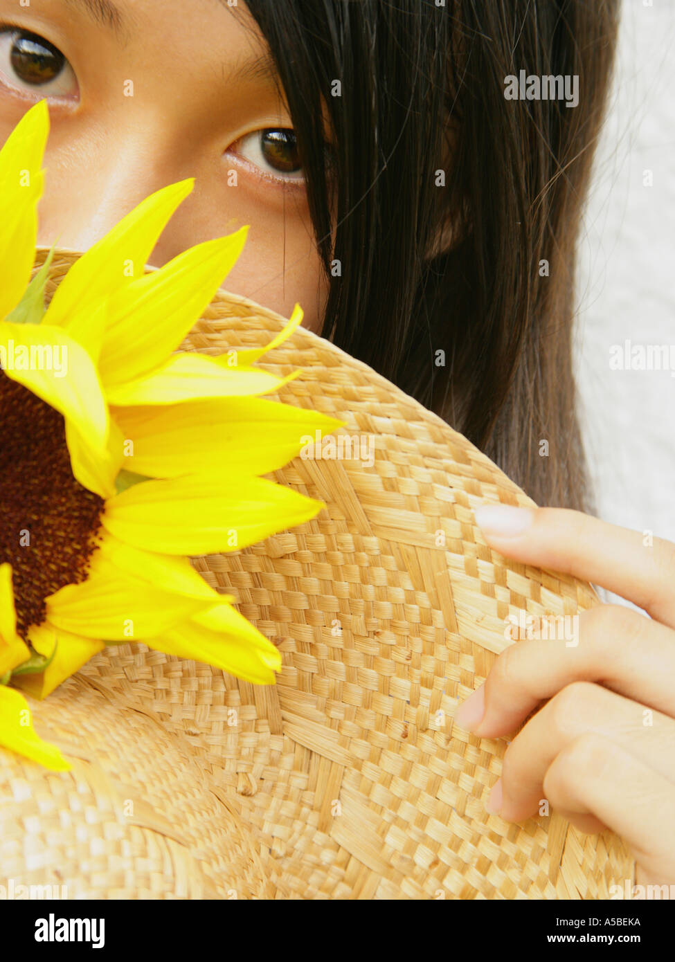 Portrait of a teenage girl holding a sunflower Stock Photo - Alamy