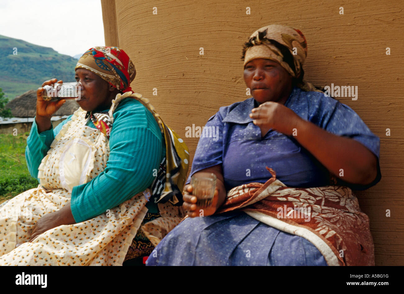 Two women resting with drink, South Africa Stock Photo