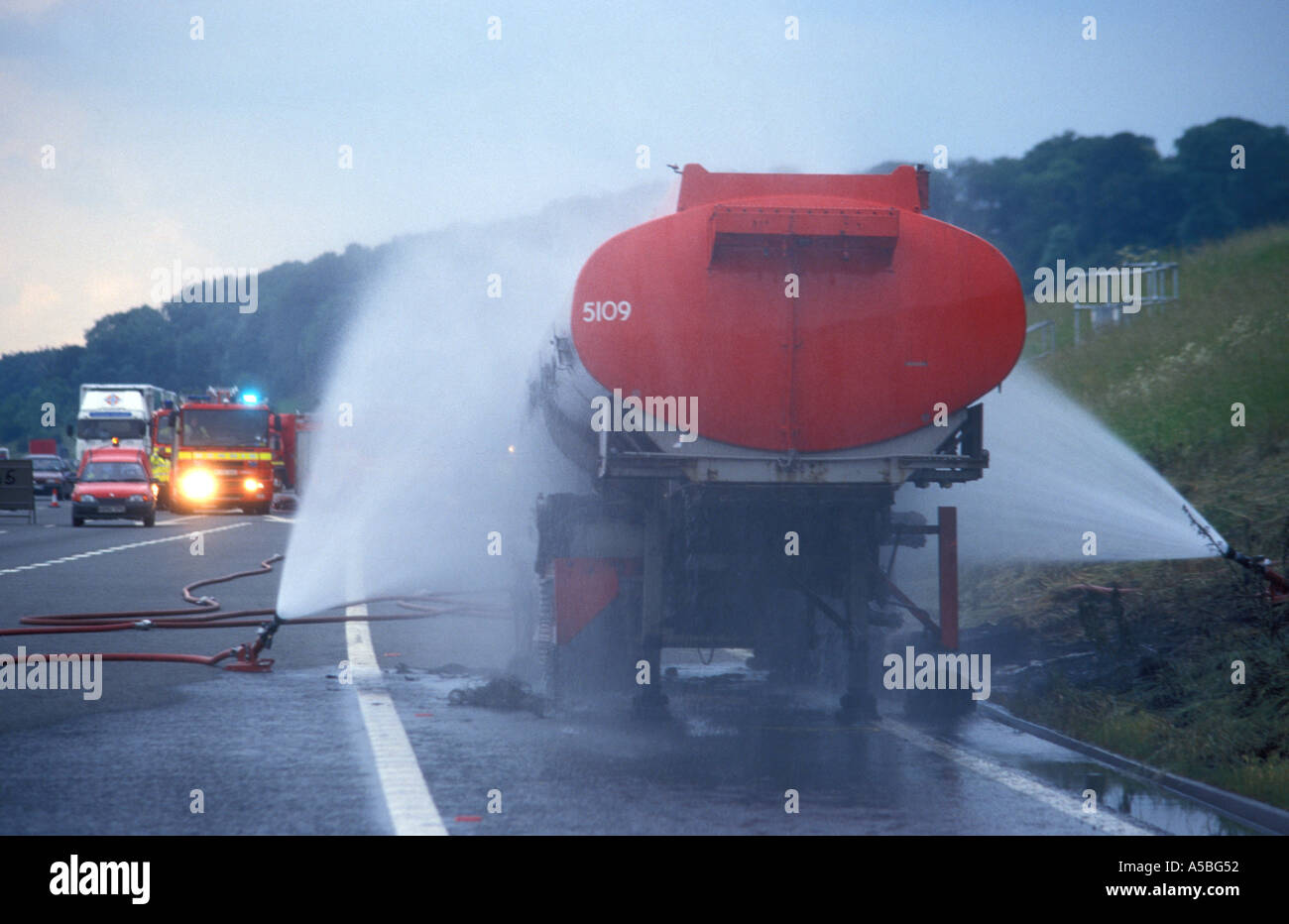 Cooling tanker carrying dangerous chemicals after is has caught fire on the M5 motorway in Gloucestershire England Stock Photo