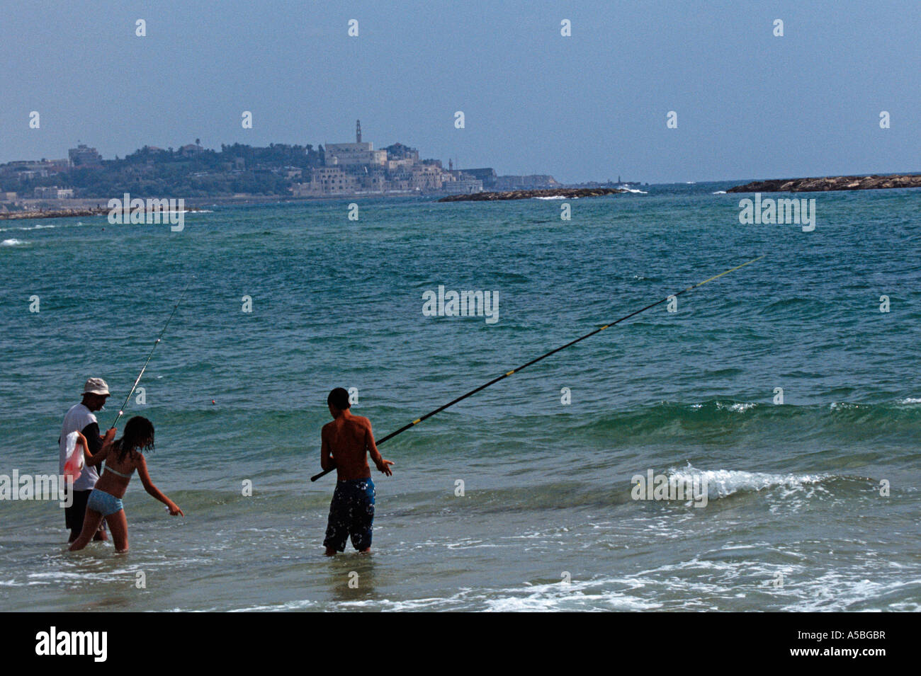 People at a beach in Tel Aviv with Jaffa in the background Stock Photo