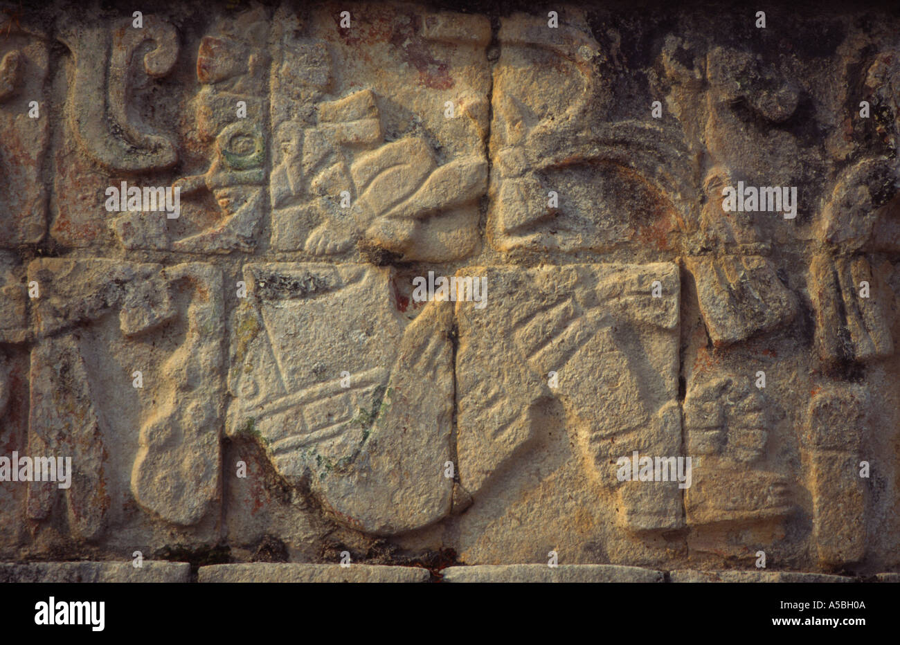 Mexico Yucatan Chichen Itza Inca archeological site stone carvings Tomb de los guerreros figures of sitted person  Stock Photo