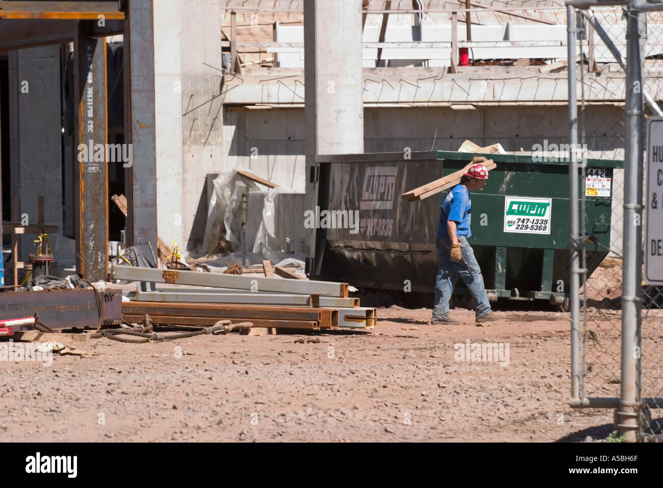 Worker carrying materials at a construction site  Stock Photo