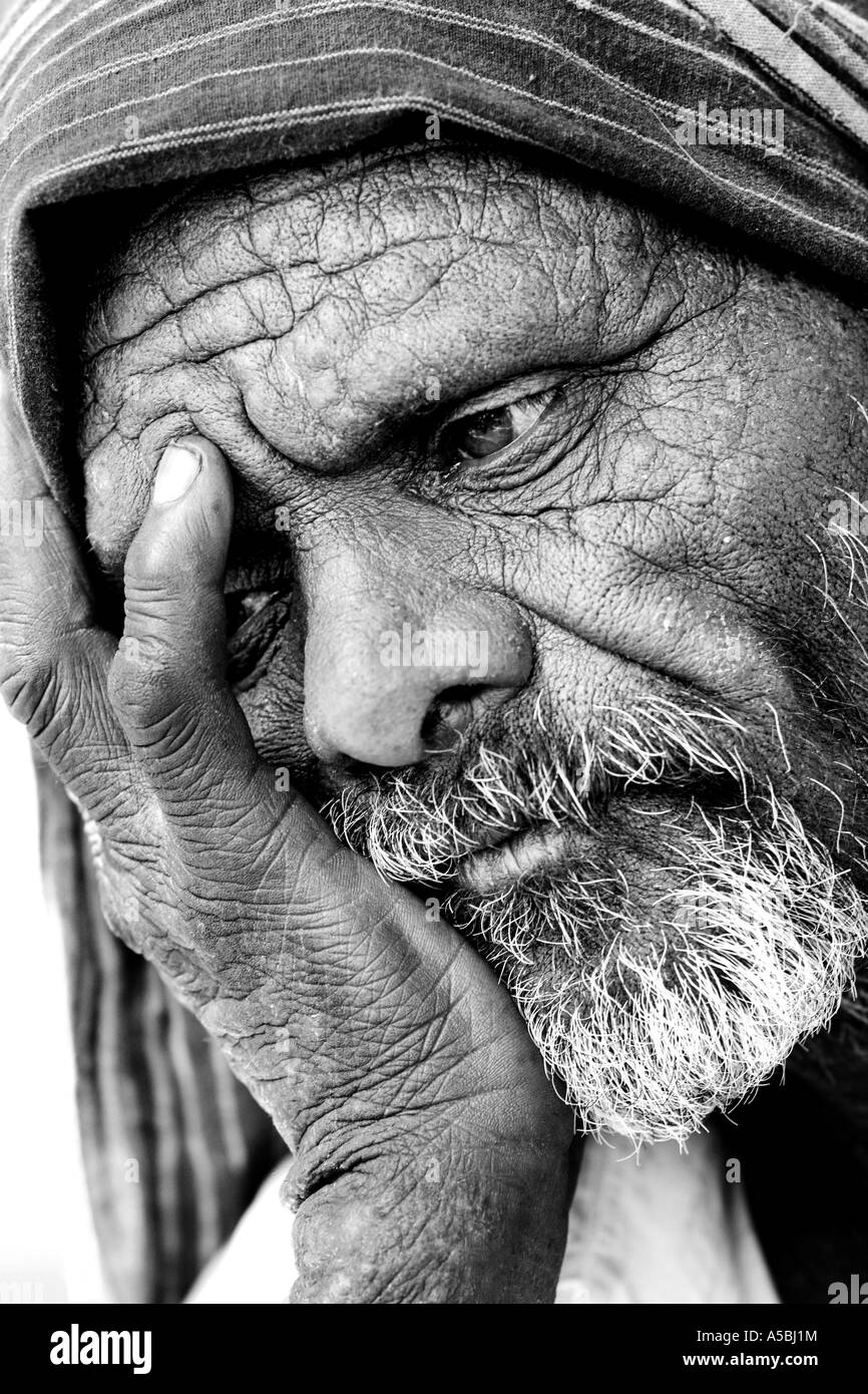 Old Indian man looking distant and introspective. Andhra Pradesh, India. Black and white Stock Photo