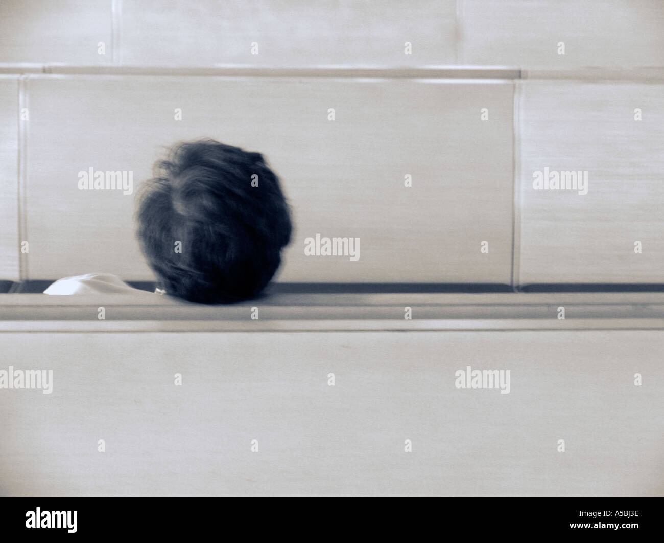 Man resting in public seating at airport Stock Photo