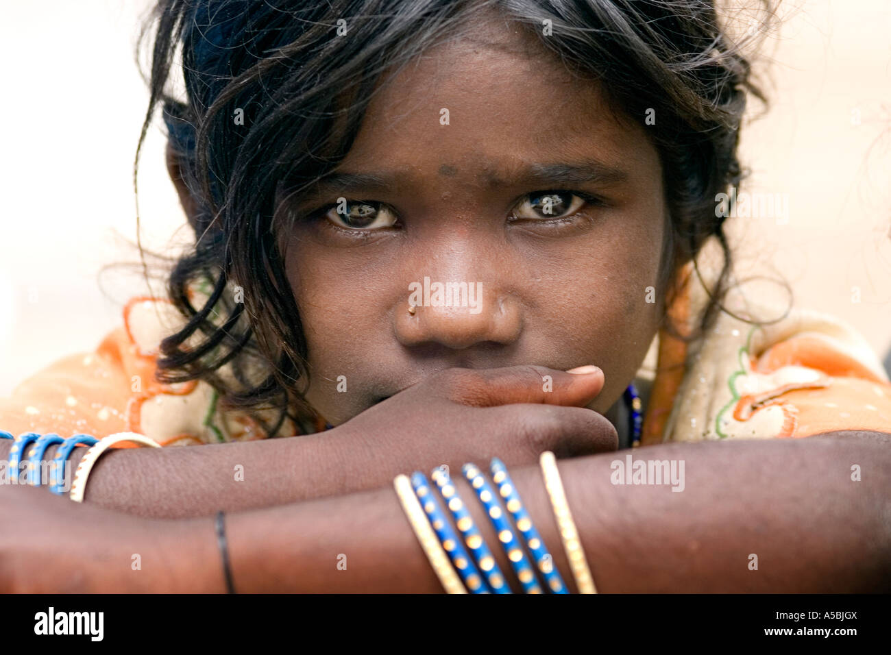 Little Indian street girl staring intensely into camera. Selective focus. Stock Photo