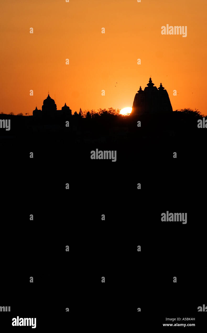 Silhouette profile of Indian ashram building architecture and sunset in the south India town of Puttaparthi Stock Photo