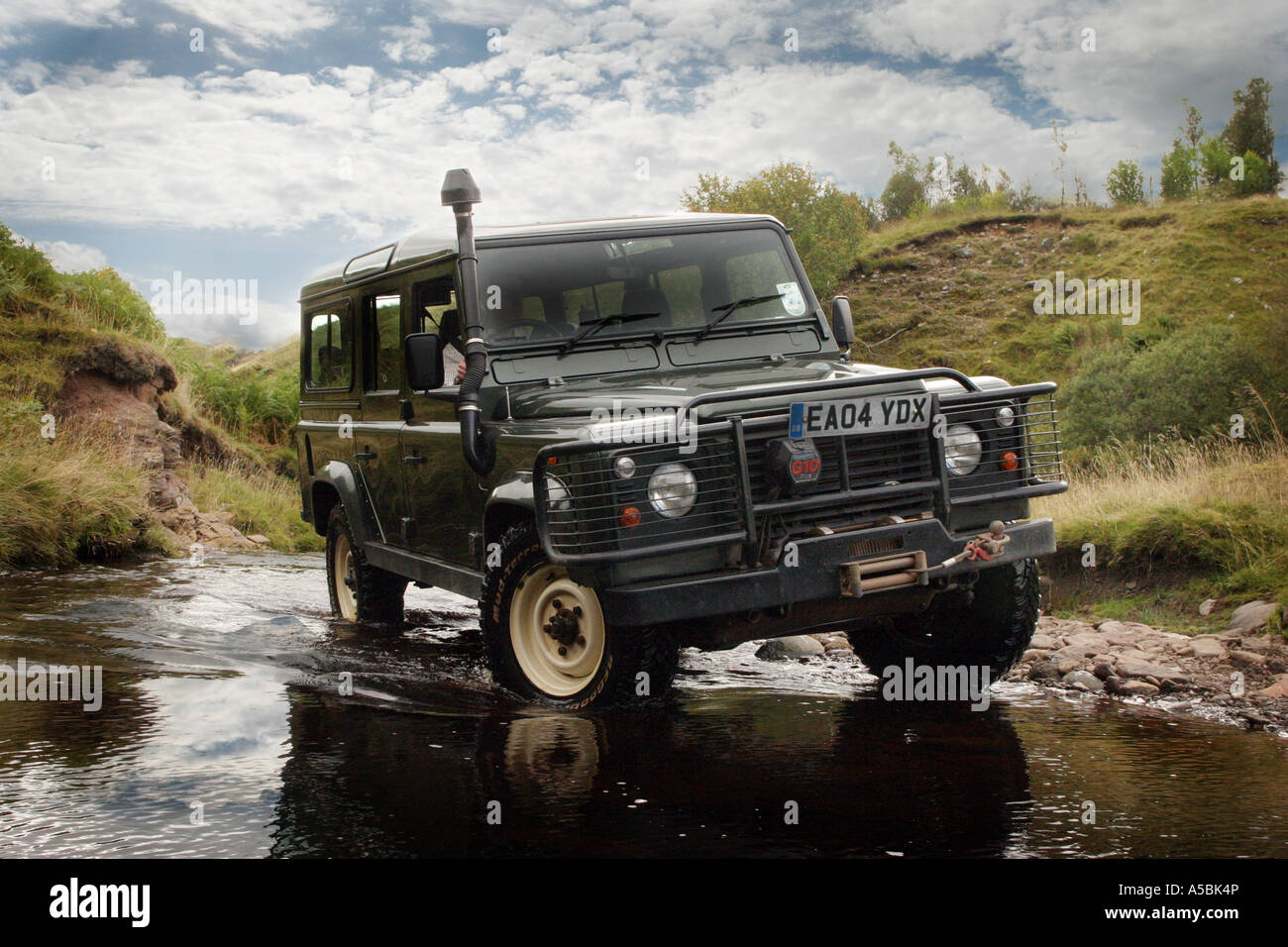 Landrover Defender Off Road crossing a stream Stock Photo