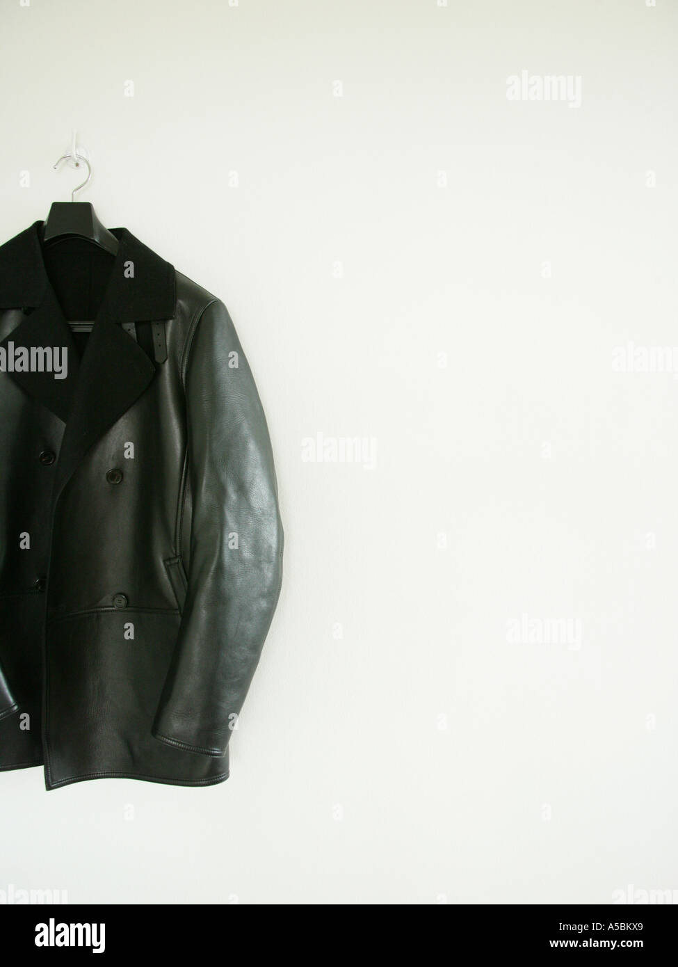 Black leather jacket hanging on a hanger Stock Photo Alamy