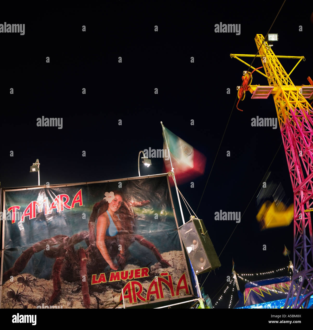 Spiderwoman funfair attraction at night in Mexico surreal weird unusual image concept greeting card idea Stock Photo