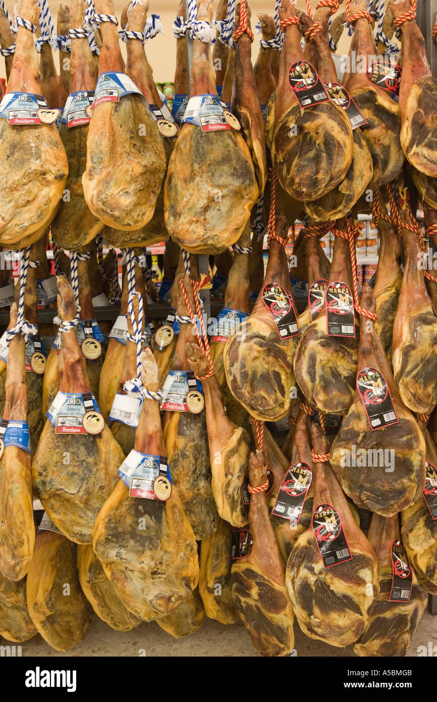 Serrano hams hanging in Spanish supermarket Stock Photo Alamy
