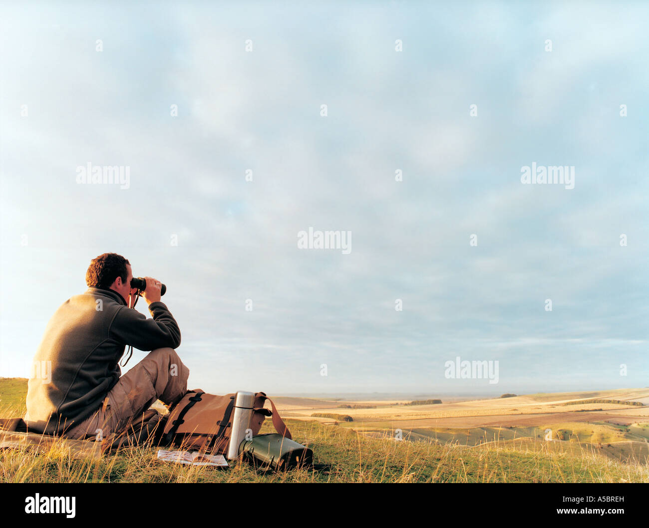 Lone Man, Bird Watching on Share Hill, Wiltshire, UK Stock Photo