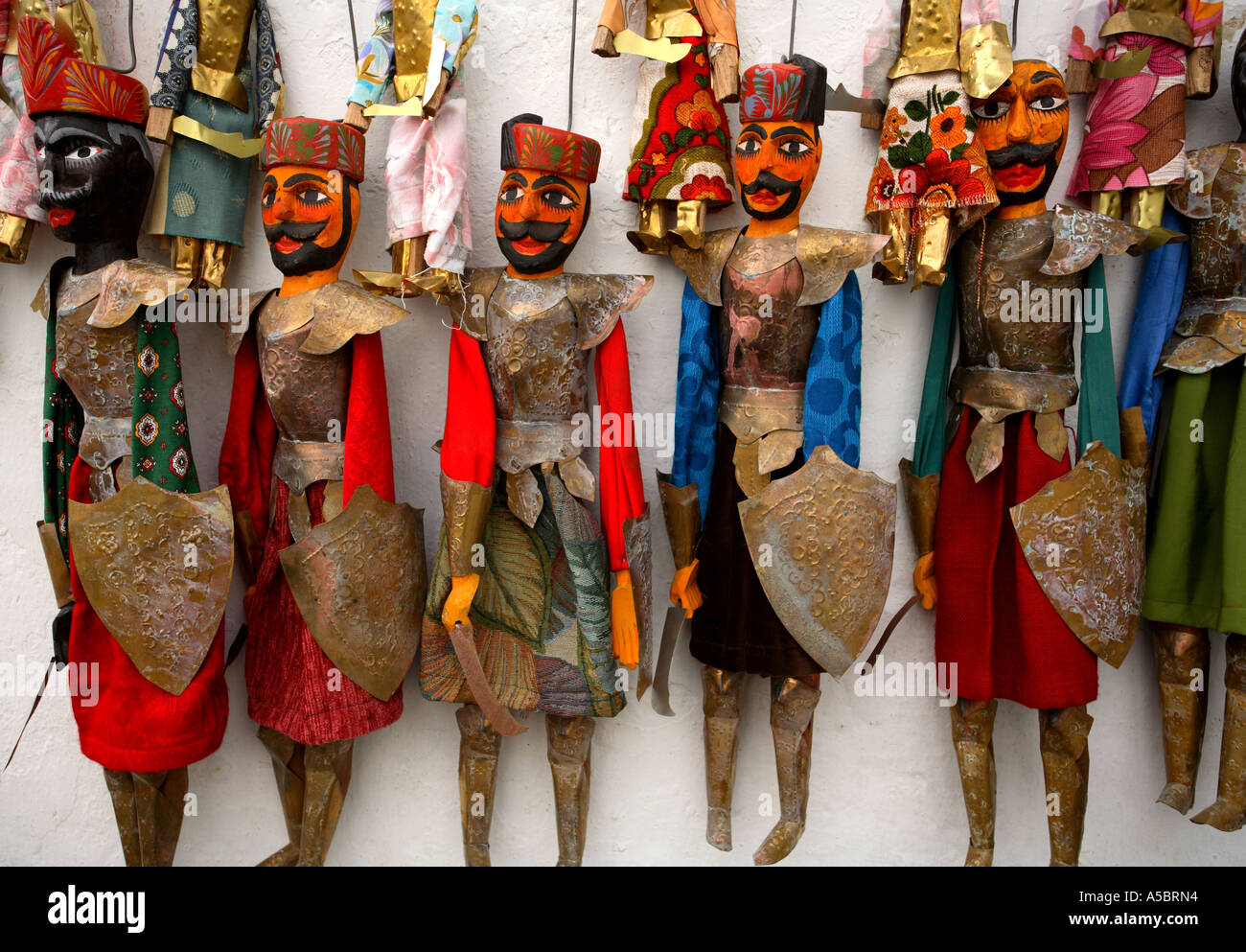 Horizontal close up landscape detail of brightly coloured puppets hanging on a wall, Sidi Bou Said, Tunis, Tunisia, North Africa Stock Photo