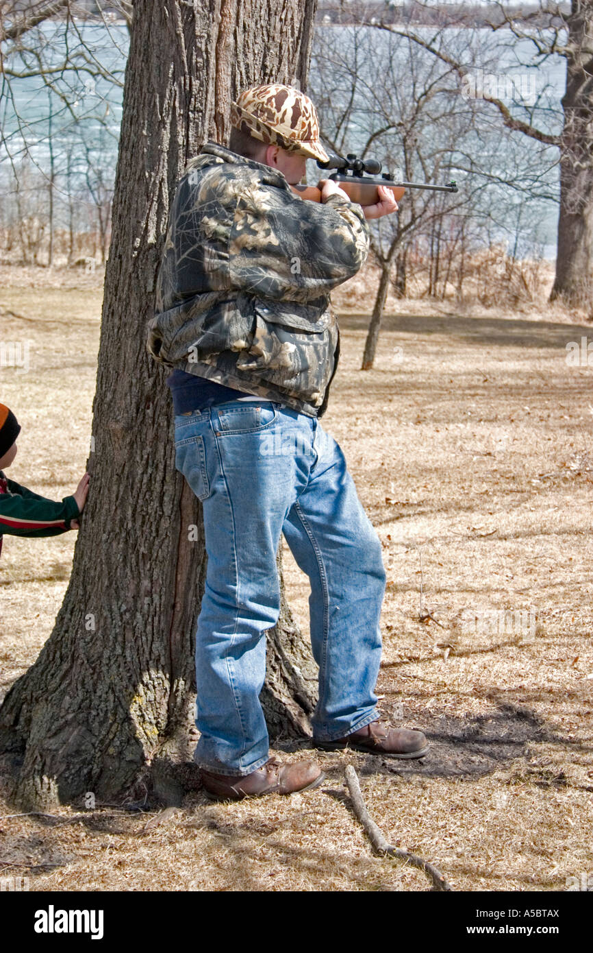 Father showing right of passage with air rifle target practice. Clitherall Minnesota USA Stock Photo