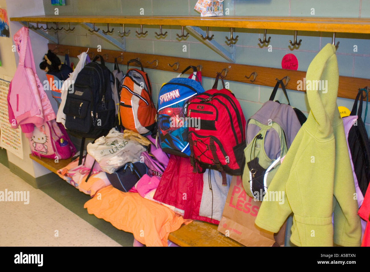 Childrens school cloakroom with jackets and colorful backpacks. Horace Mann Elementary School St Paul Minnesota USA Stock Photo