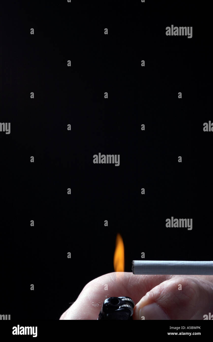 Light a cigarette with a lighter, black background Stock Photo Alamy