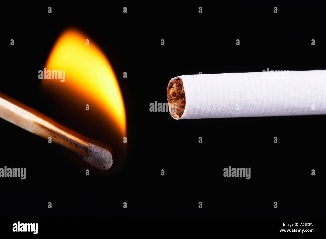 Light a cigarette with a match, black background Stock Photo Alamy
