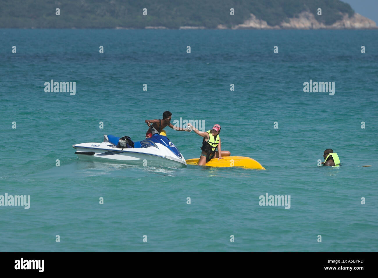 Jet ski driver rescues womans unprotected digital camera when kayak overturns Chaweng Beach Ko Samui island Thailand Stock Photo
