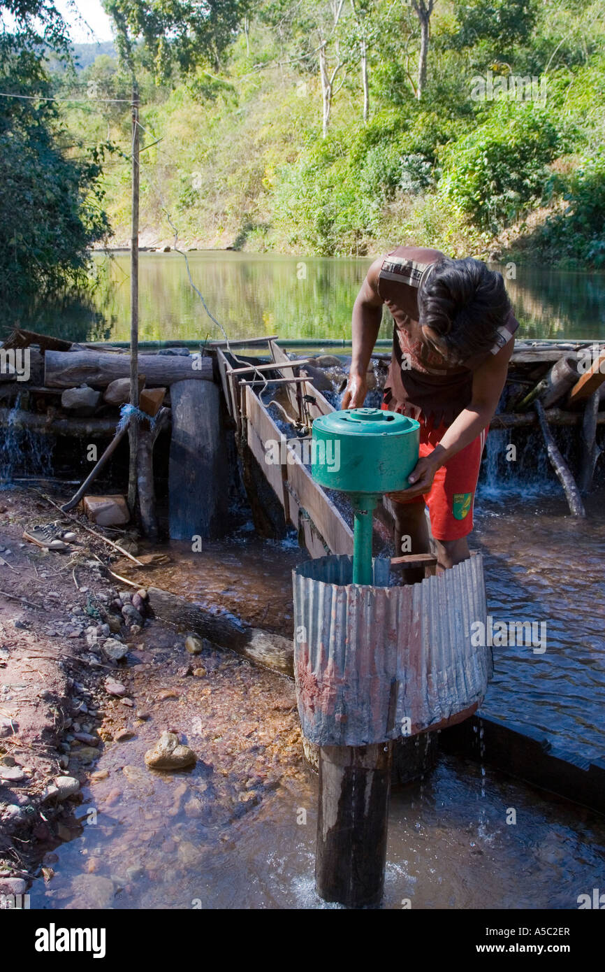Man Fixing the Towns very small Hydro Electric Generator near Hongsa Laos Stock Photo