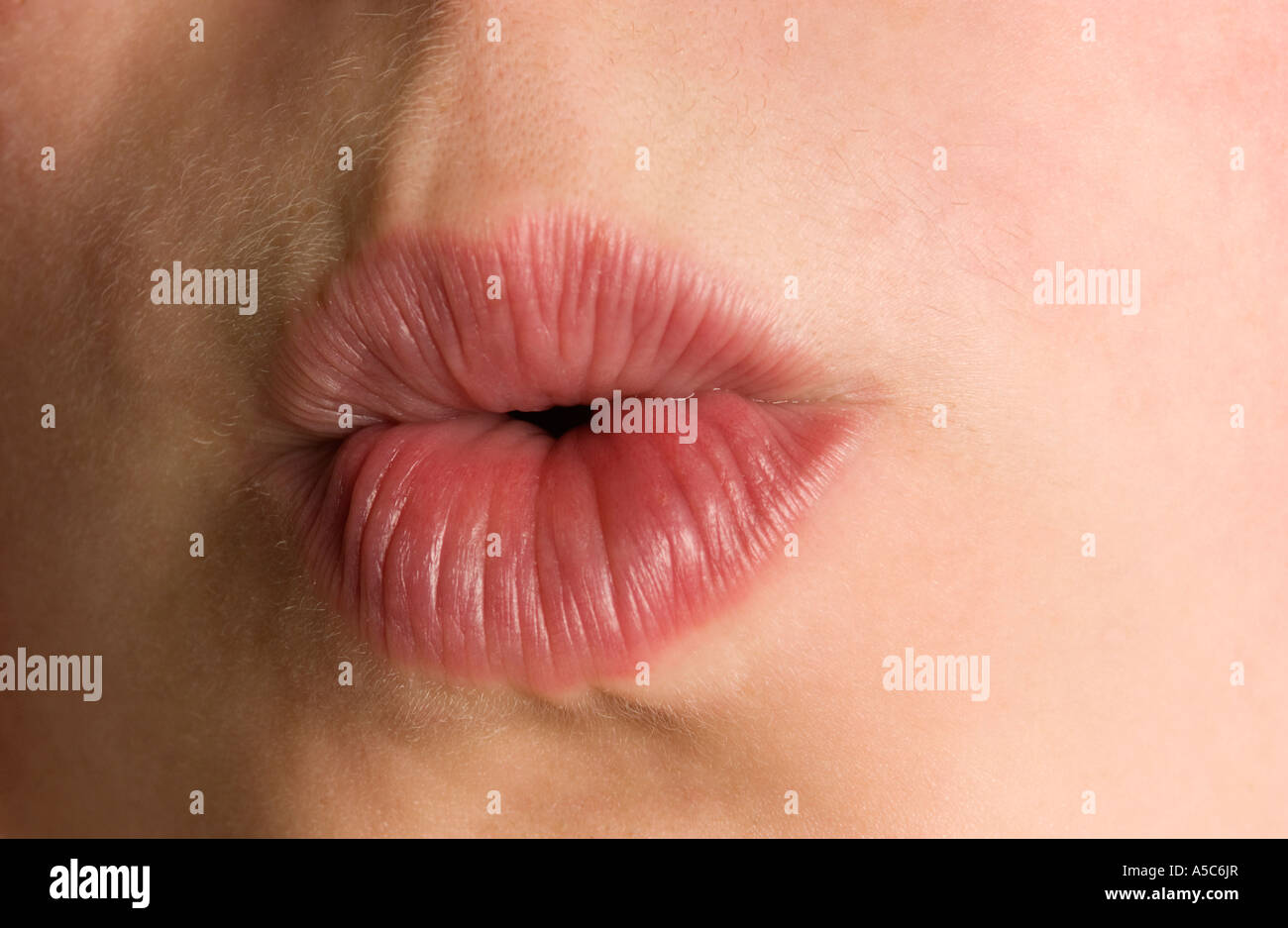 Teenage girl pursing lips to whistle Stock Photo