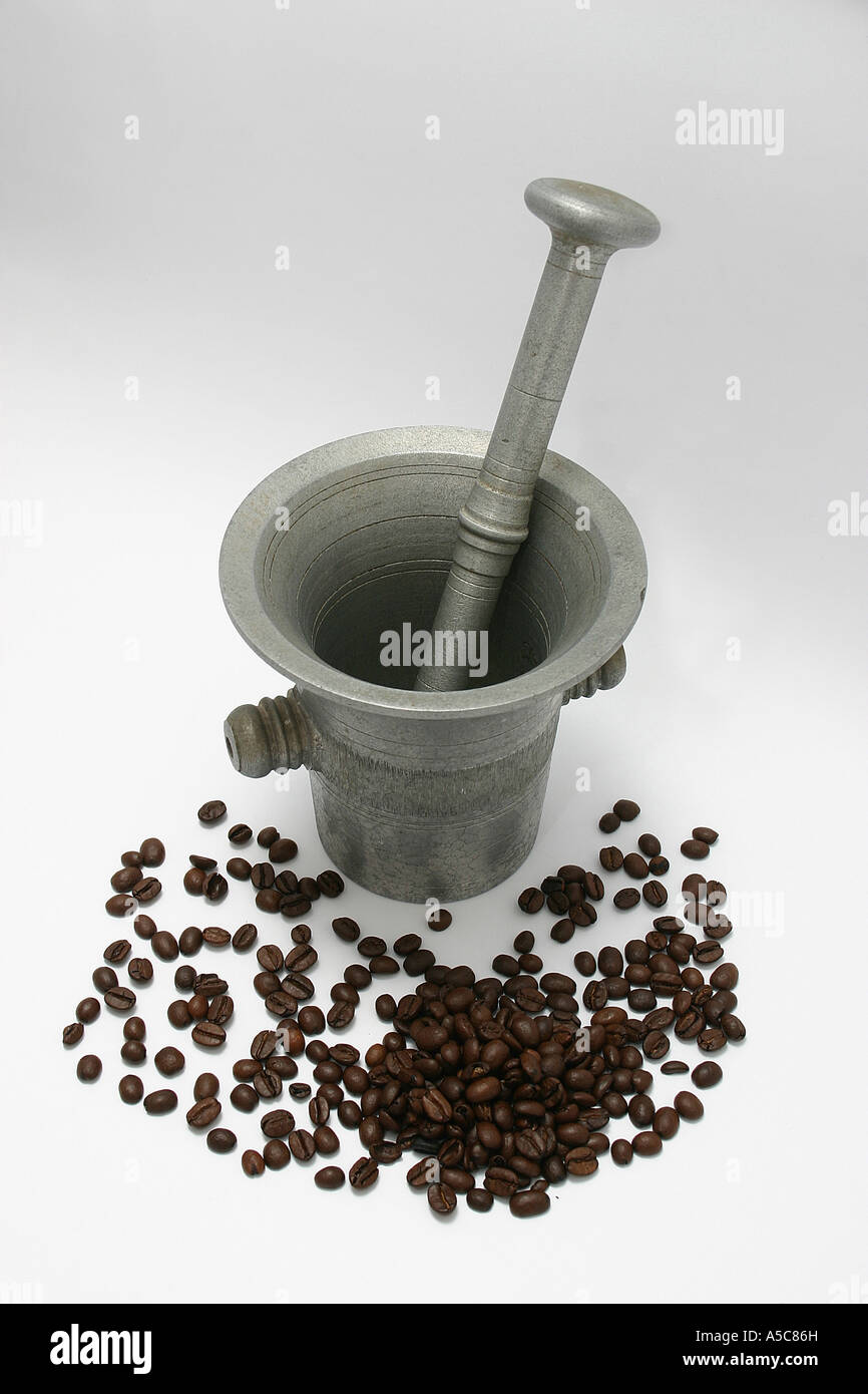 old bronze pestle and mortar used to finely grind or pound the coffee