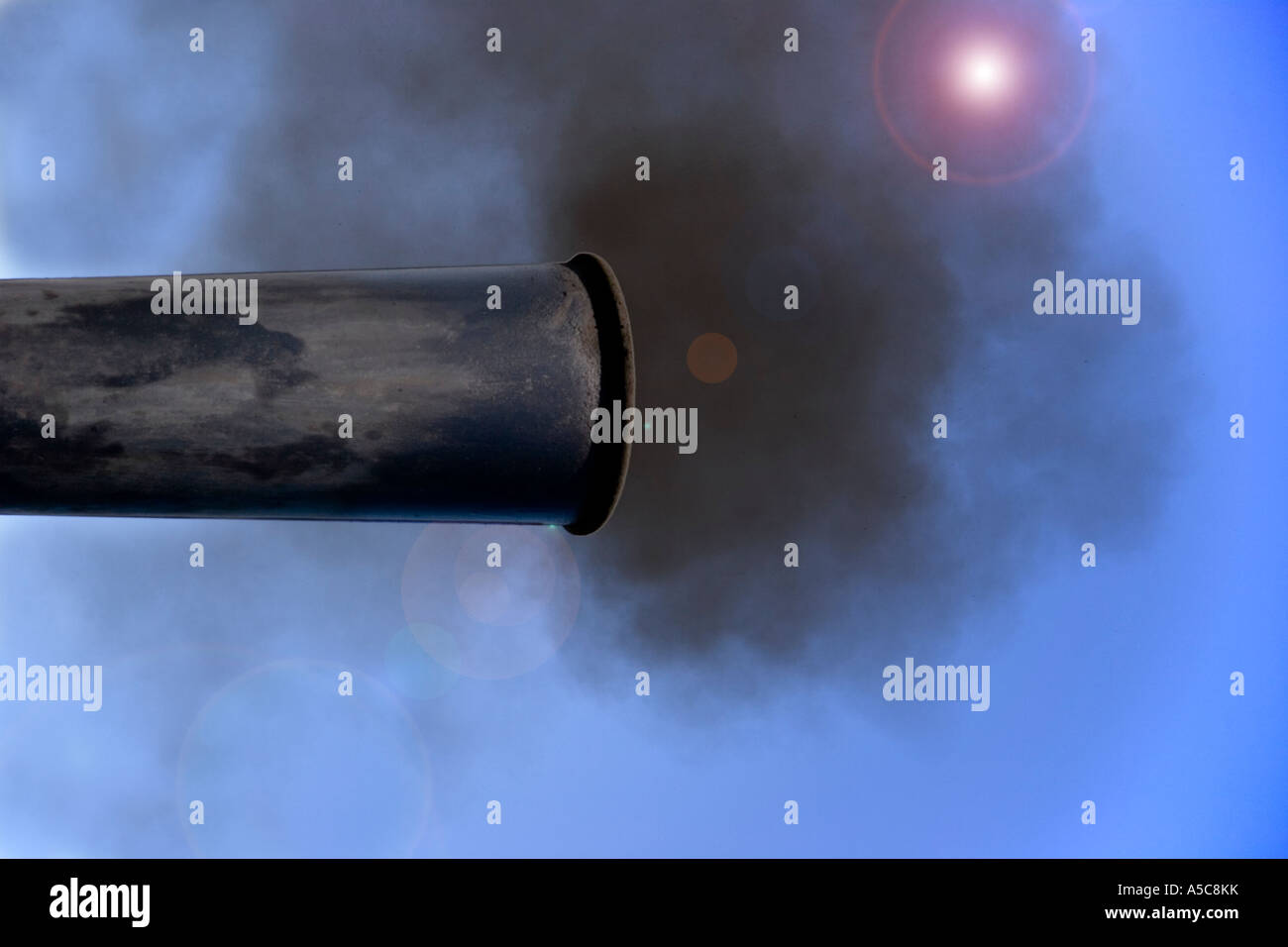 Exhaust pipe belching fumes into the atmosphere Stock Photo