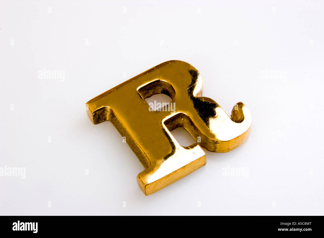 Brass paperweight in the shape of the letter R Stock Photo Alamy