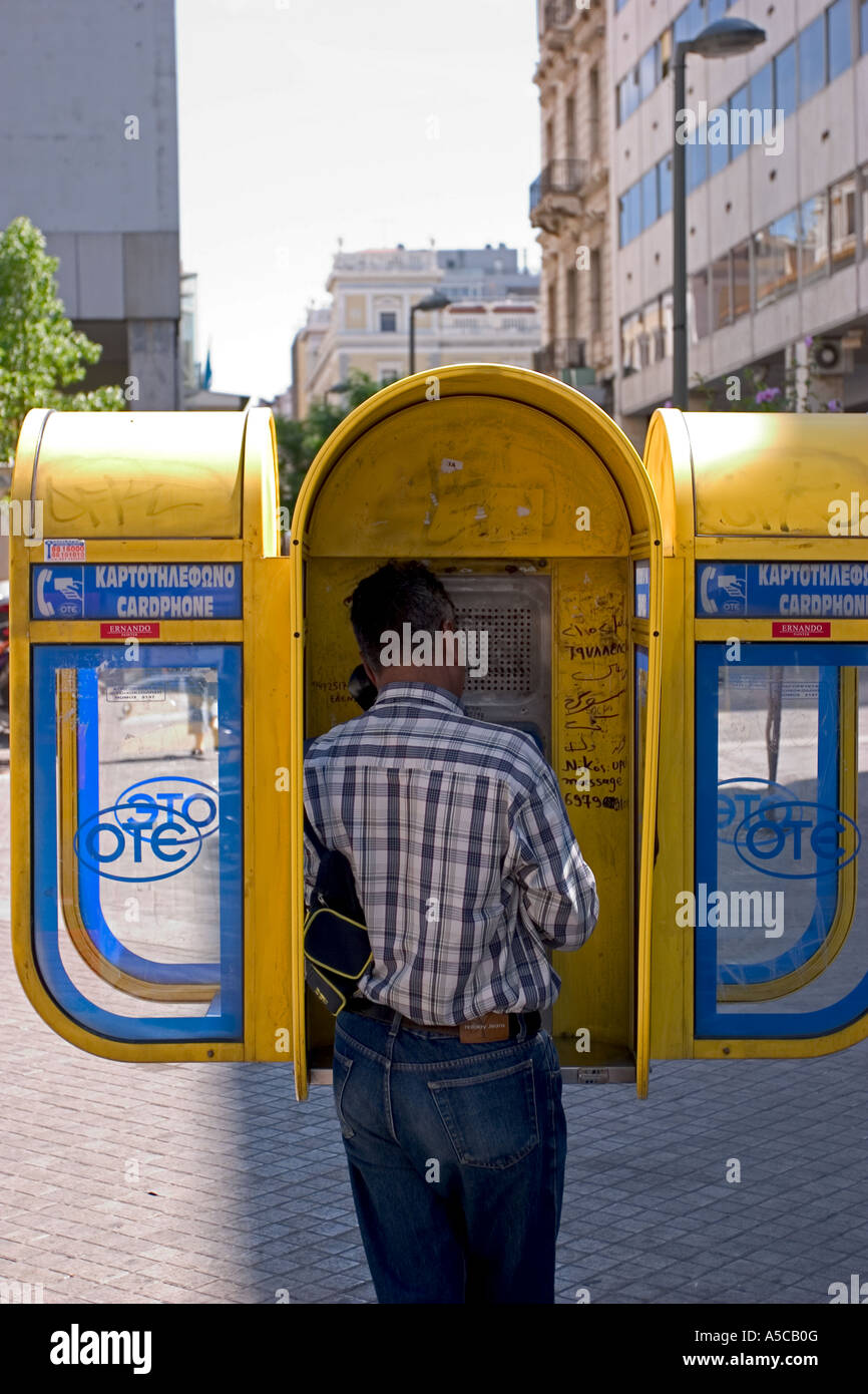 man in yellow public phone in manhattan in new york usa Stock Photo