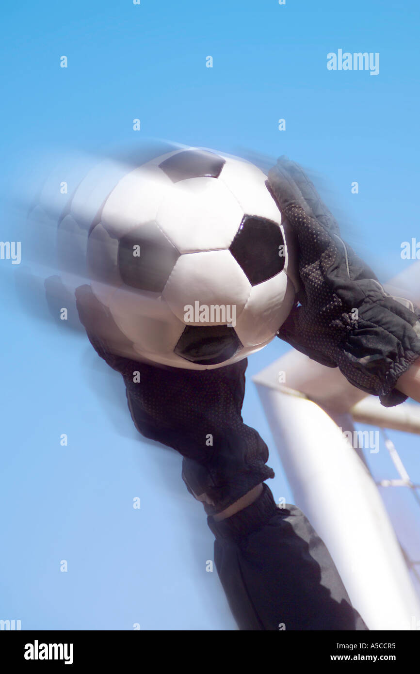 Goalkeeper holding soccer ball, low angle view Stock Photo