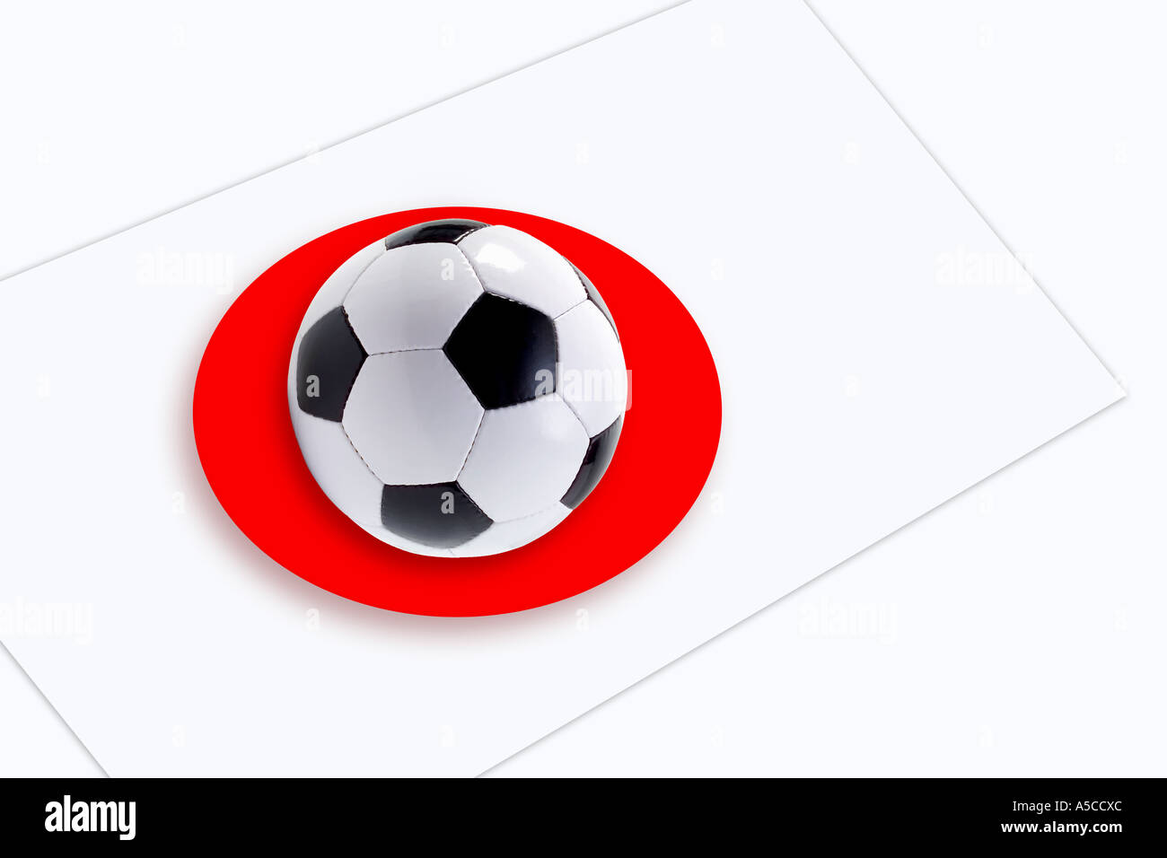Soccer ball in centre of Japanese flag, elevated view Stock Photo