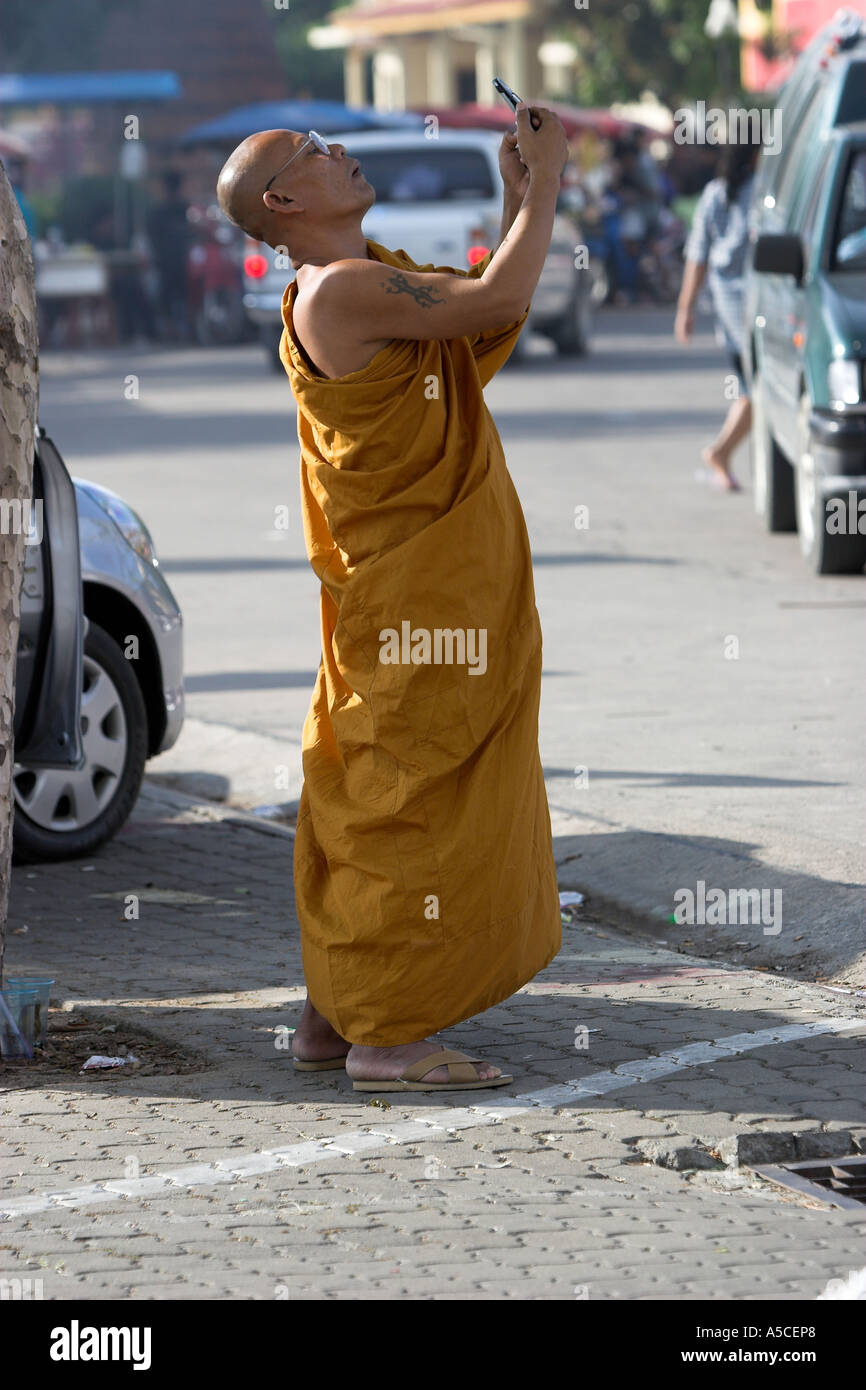 Monk takes pictures with mobile telephone camera Wat Chalong Phuket Thailand Stock Photo